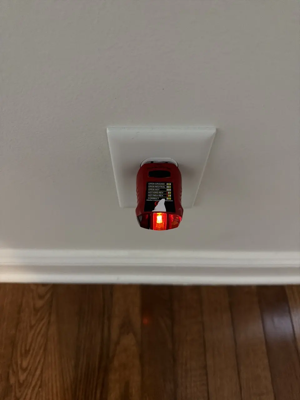 Plug-in outlet tester checking wiring at a wall receptacle during a home inspection